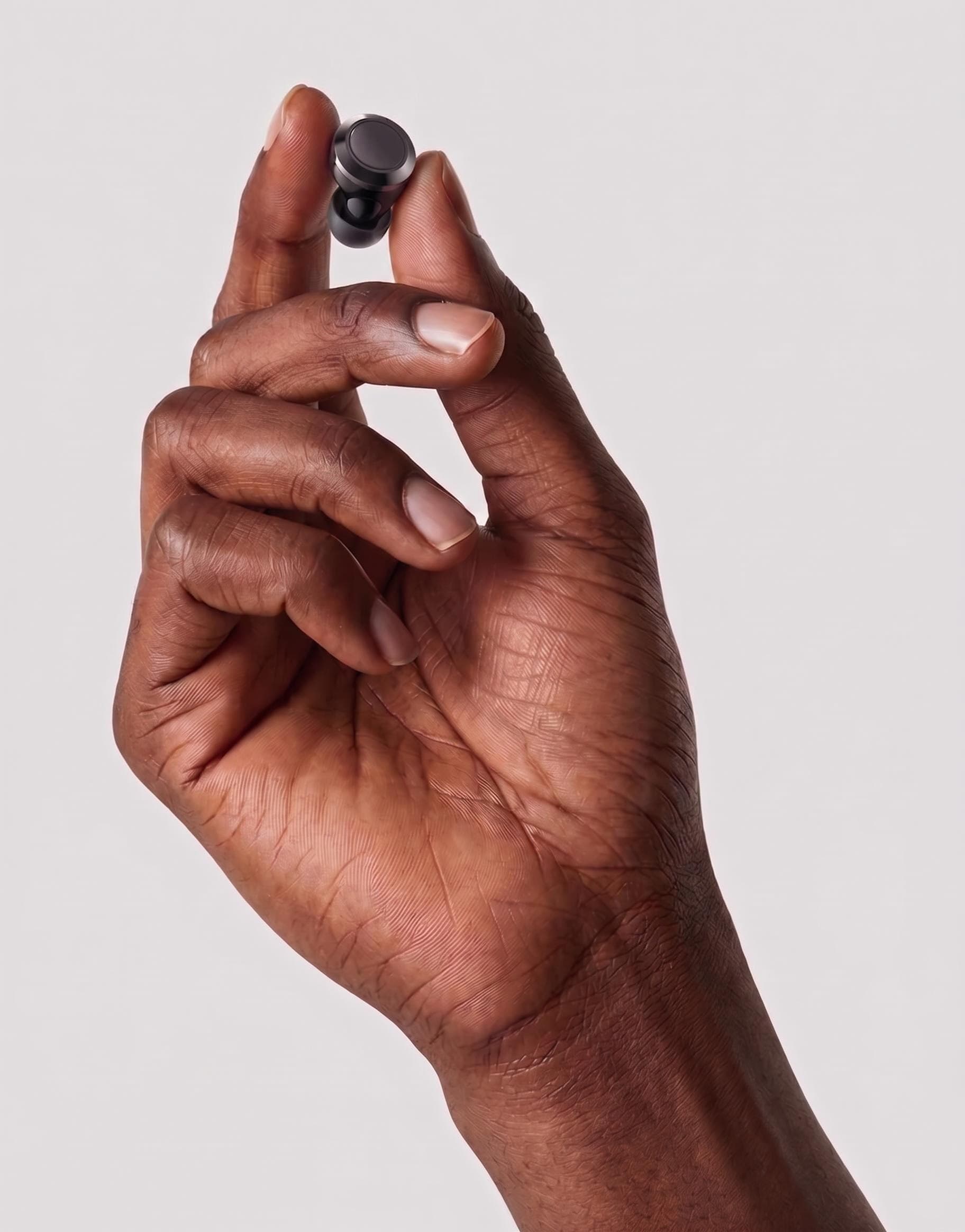 Black FILTERS ear filter held between fingers
